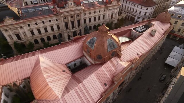 Aerial drone view of Palatul Pinacotecii, also known as Dacia-Romania Palace, in Bucharest&rsquo;s Old Town, surrounded by historic rooftops and streets at golden hour.