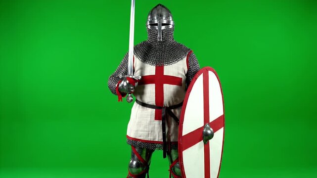 Medieval Knight in Full Armor with Sword and Shield on Green Screen.