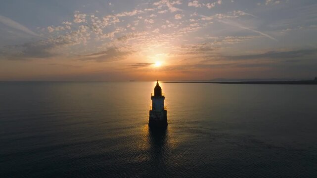 Plover Scar Derelict Lighthouse. Morecambe Bay, Lancashire, UK. Lighthouse positioned In Front Of Sunset Glow. Slow Approach With Seabirds Flying Past.