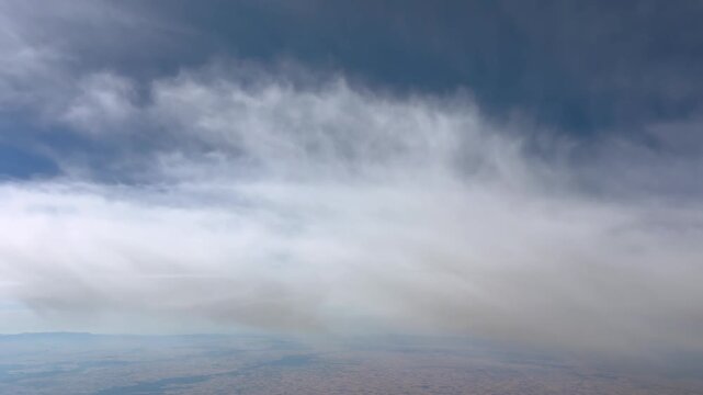 immersive pilot&rsquo;s view while flying at cruise level through ethereal clouds, and under a jet trail flying above in a supersonic speed flight.