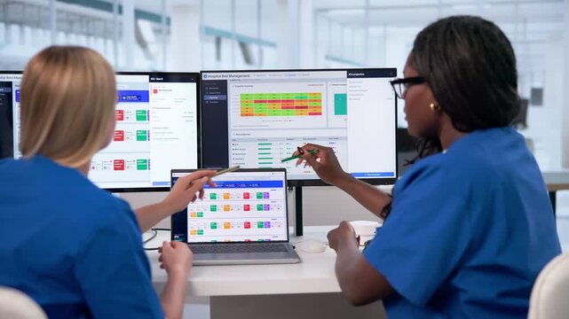 Hospital Manager Reviews Patient Flow Dashboard On Laptop