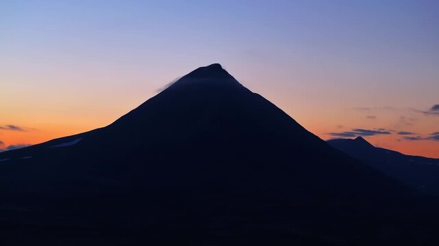 Orange twilight glows behind Bifrost mountain, clouds drift, midnight hyperlapse