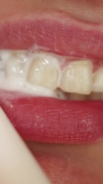 Close-up of foamy toothpaste on teeth and lips during brushing