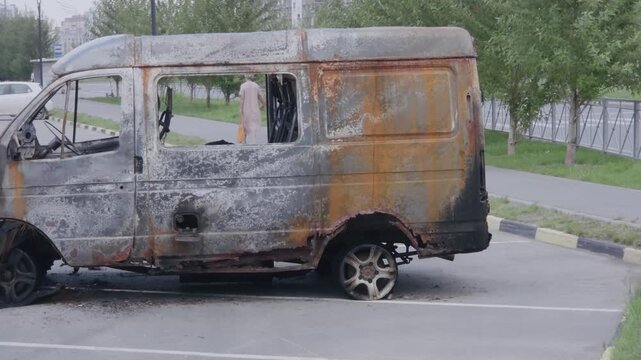 Abandoned Wreck of a Burnt Commercial Vehicle on City Street