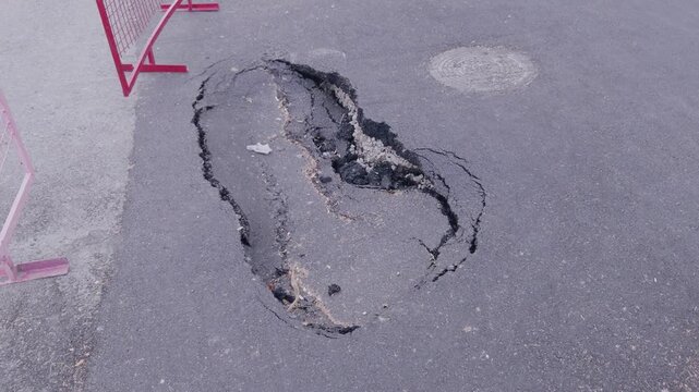 footprint observed on concrete or asphalt surface in urban construction site with neutral, static scene and top-down perspective, gray and black tones, clean background, modern design.