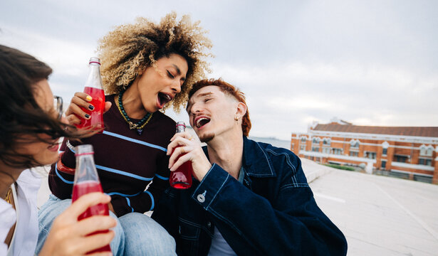 Friends celebrating on a rooftop with drinks