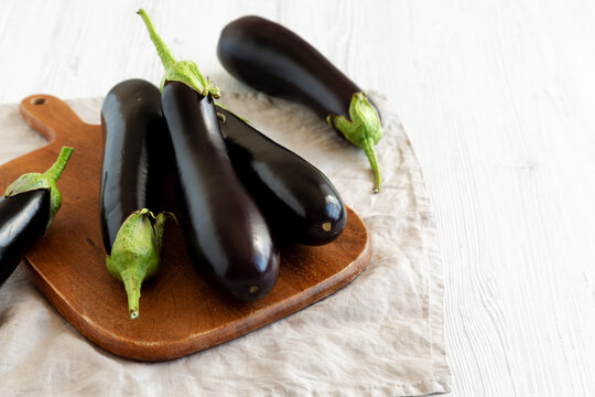 Raw Organic Eggplant on a Wooden Board