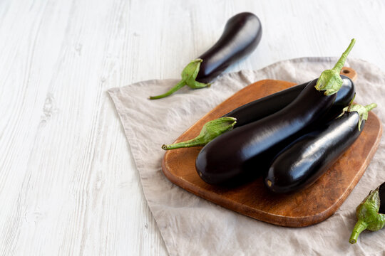 Raw Organic Eggplant on a Wooden Board