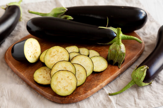 Raw Organic Eggplant on a Wooden Board