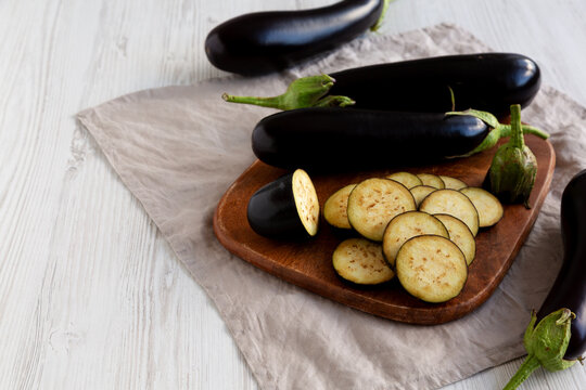 Raw Organic Eggplant on a Wooden Board