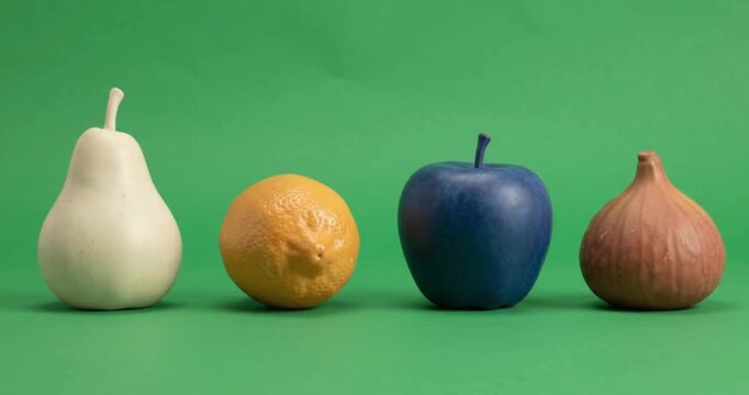 3D colorful fruits white pear yellow lemon blue apple and brown fig on green screen background