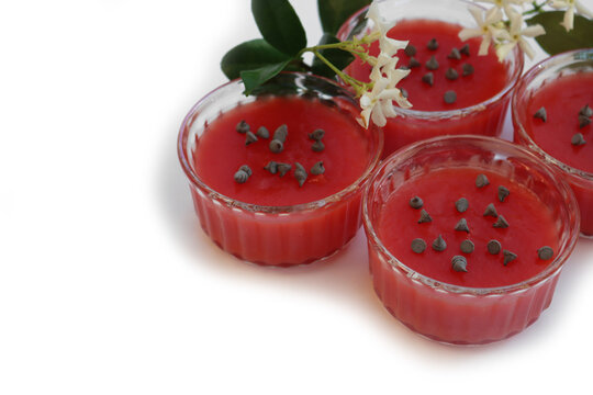 Traditional Sicilian Watermelon Puddings called Gelo di Mellone with chocolate chips  in glass bowls on white background with jasmin flowers