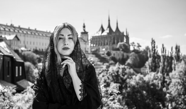 Woman exploring historic streets of Kutna Hora with St. Barbara Cathedral in background, Czech Republic travel concept