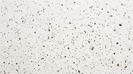 Naklejka premium White speckled paper texture with black grain particles and recycled material surface.