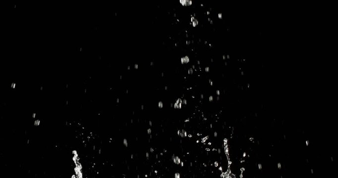 A truly stunning visual of water droplets splashing vigorously after a heavy object forcefully hits the surface, making it ideal for creative motion graphics and unique abstract designs