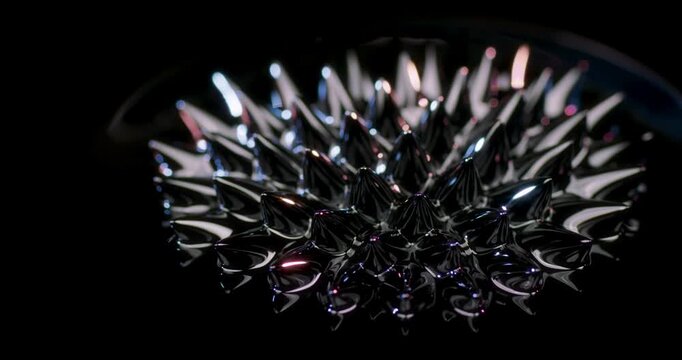 This captivating abstract video showcases mesmerizing shapes created by ferrofluid swirling on a deep black backdrop. Its the perfect choice for enhancing motion graphics and visual effects projects