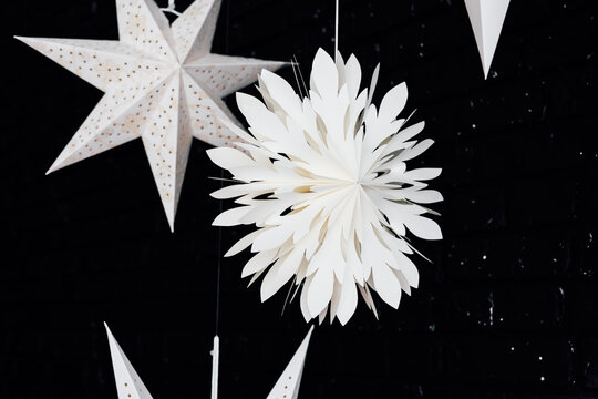 Hanging Christmas paper decorations in white and black setting for an event