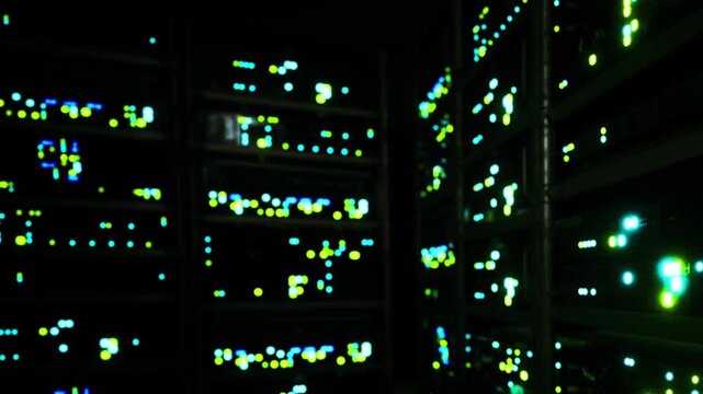 Bright lights can be seen flashing in a dark server room. The colors change as various machines operate, illuminating the space in different shades. It shows technology in action.