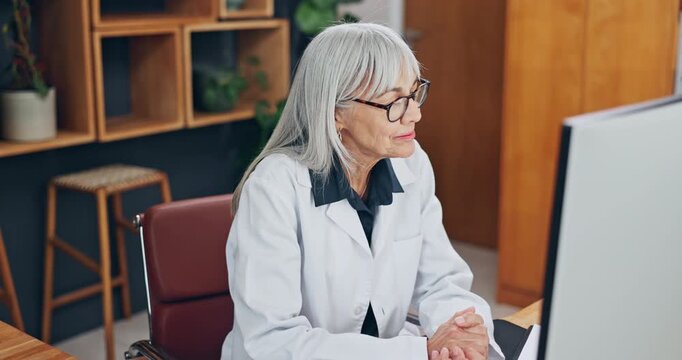 Doctor, wave and video call in office with computer, online consultation and discussion for advice. Mature woman, hello and virtual meeting in clinic with pc, telehealth appointment and conversation.