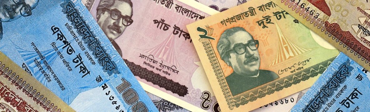 Bangladeshi taka money bills in pile on table. Bangladesh BDT currency cash close up