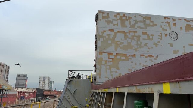 discharging wheat in bulk from ship in port.