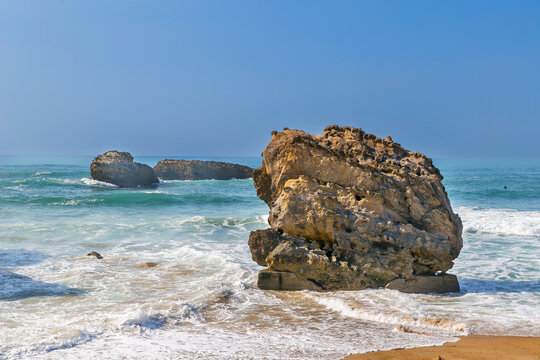 Rocks on the Bay of Biscay in Biarritz, France. Sunny daylight with blue sky. Atlantic ocean coast