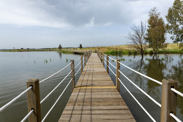 Fototapeta premium Wooden pier extending over alqueva lake in alentejo portugal