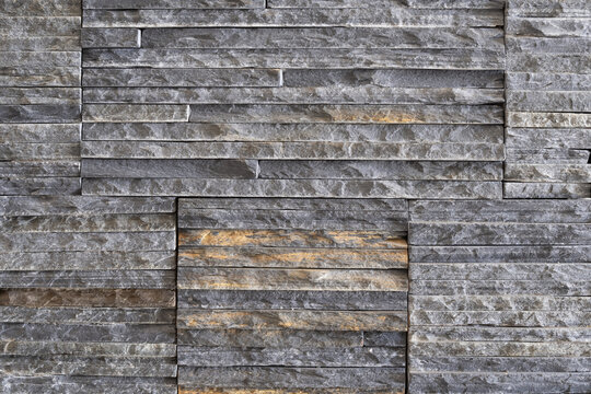 Textured decorative stone cladding made of narrow stacked pieces for modern wall finishing and interior design