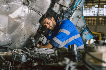 Plakat Hispanic Latin Indian Male Mechanic Repairing Truck Engine In Auto Service Garage Workshop.