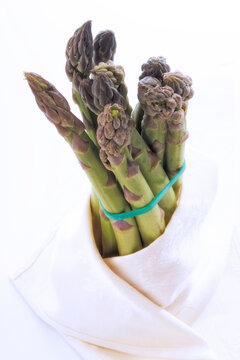 Bunch asparagus wrapped in a cloth, close-up