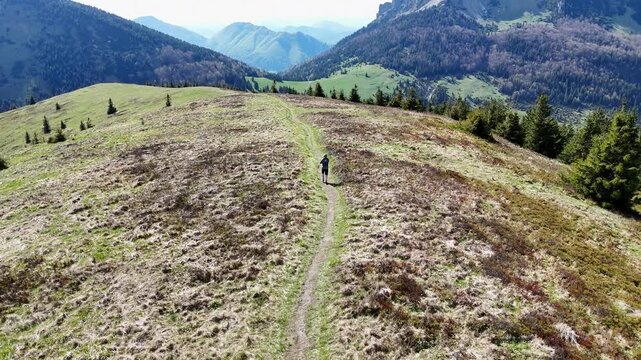 Aerial View Following Trail Runner Along Scenic Mountain Ridge