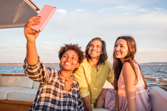 Friends on a boat trip taking a selfie
