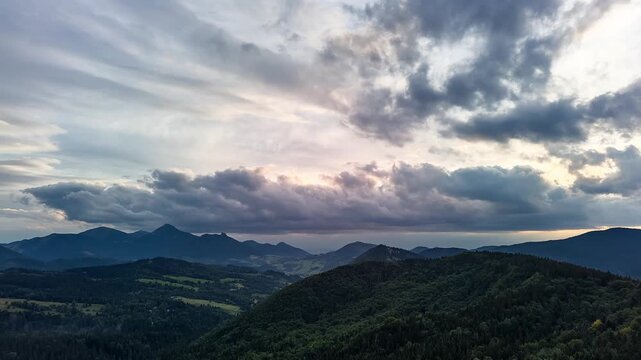 Cinematic Aerial Hyperlapse of Dark Storm Clouds Rolling Over Mountain Valley at Dusk