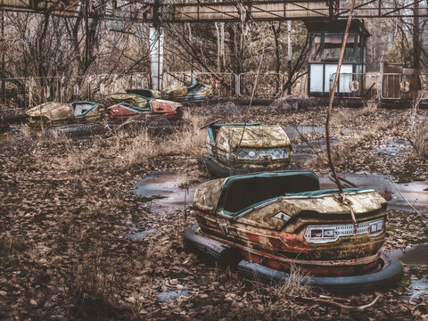 abandoned car in the countryside , amusement park , autoscooter , electric car , mobility , disaster  , nuclear disaster ,chernobyl ,open air museum ,memories 