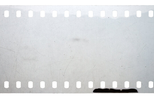 Dusty and grungy 35mm film texture or surface. Perforated scratched camera film isolated on white background.