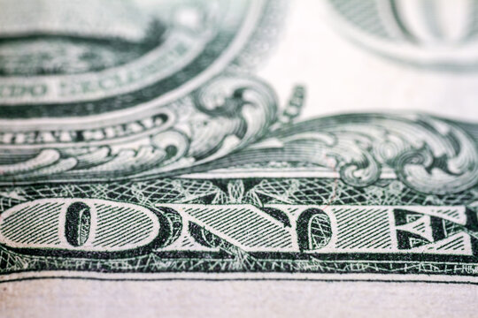 Macro close up of United States one dollar bill. American dollar background. Detailed dollars money texture. Selective focus, shallow depth of field