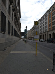Fototapeta premium European city street with bus stop sign post and classic architecture