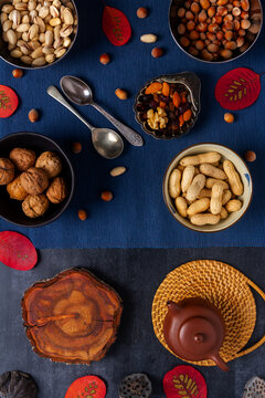 Food themed still life with crockery, various nuts and tea. Flat lay. Top view.