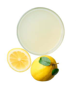 Glass of freshly squeezed lemon juice isolated on white background, top view . lemon juice in glass isolated, top view.