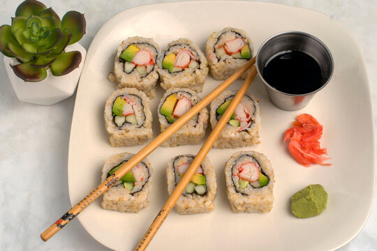 brown  rice sushi   served with soy sauce and wasabi