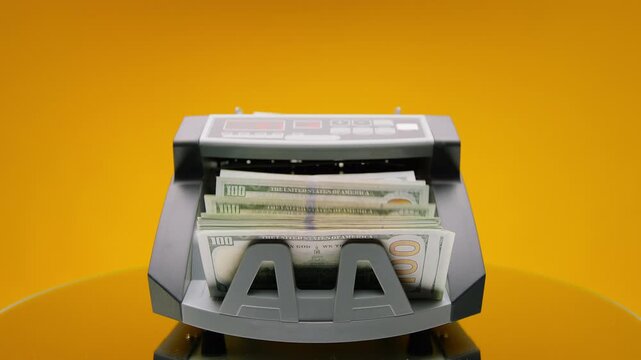 Minimal Money Counter Feeding Dollars on Yellow