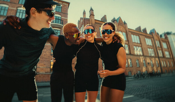 Socializing after a group run, the friends linger outdoors in the city together