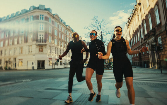 Community running unfolds on the city street with urban training and teamwork