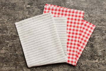 Obraz premium top view with gray kitchen napkin isolated on table background. Folded cloth for mockup with copy space, Flat lay. Minimal style