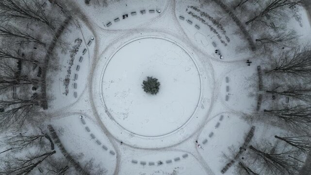 Top Down Drone View of Snow Capped Circular Park in Downtown Neighborhood of Stockholm, Sweden