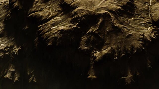 The scene shows a mountain area with rocky surfaces and uneven ground. The sun lights up the terrain and reveals the texture of the rocks. The sky appears clear with no clouds.