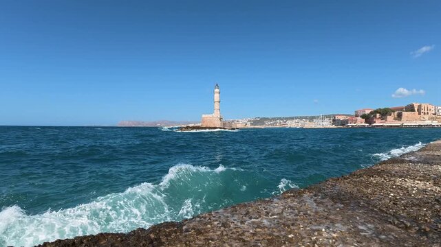 Waves crashing on the shore, as seen to the Chania lighthouse, Greece.