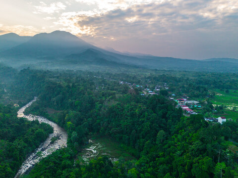 the beauty of the foggy morning panorama with sunrise and rice fields in Bengkulu, indonesia, asia