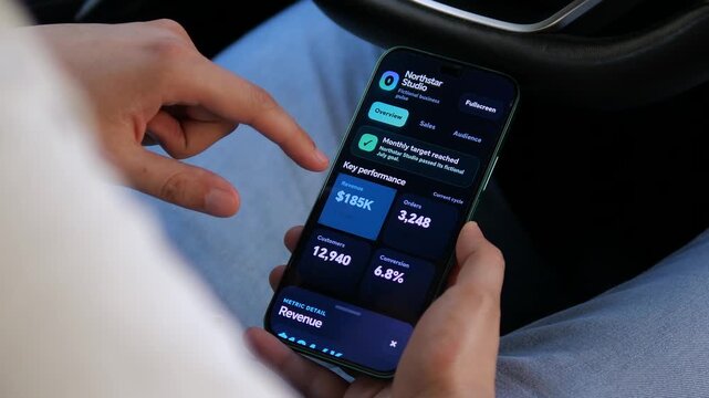 Person reviews a mobile business dashboard showing revenue growth, orders and customer metrics, reflecting the rise of real-time analytics and data-driven decision making.