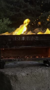 Starting a Grill Fire Close Up Fanning Burning Charcoal to Increase Heat and Flames